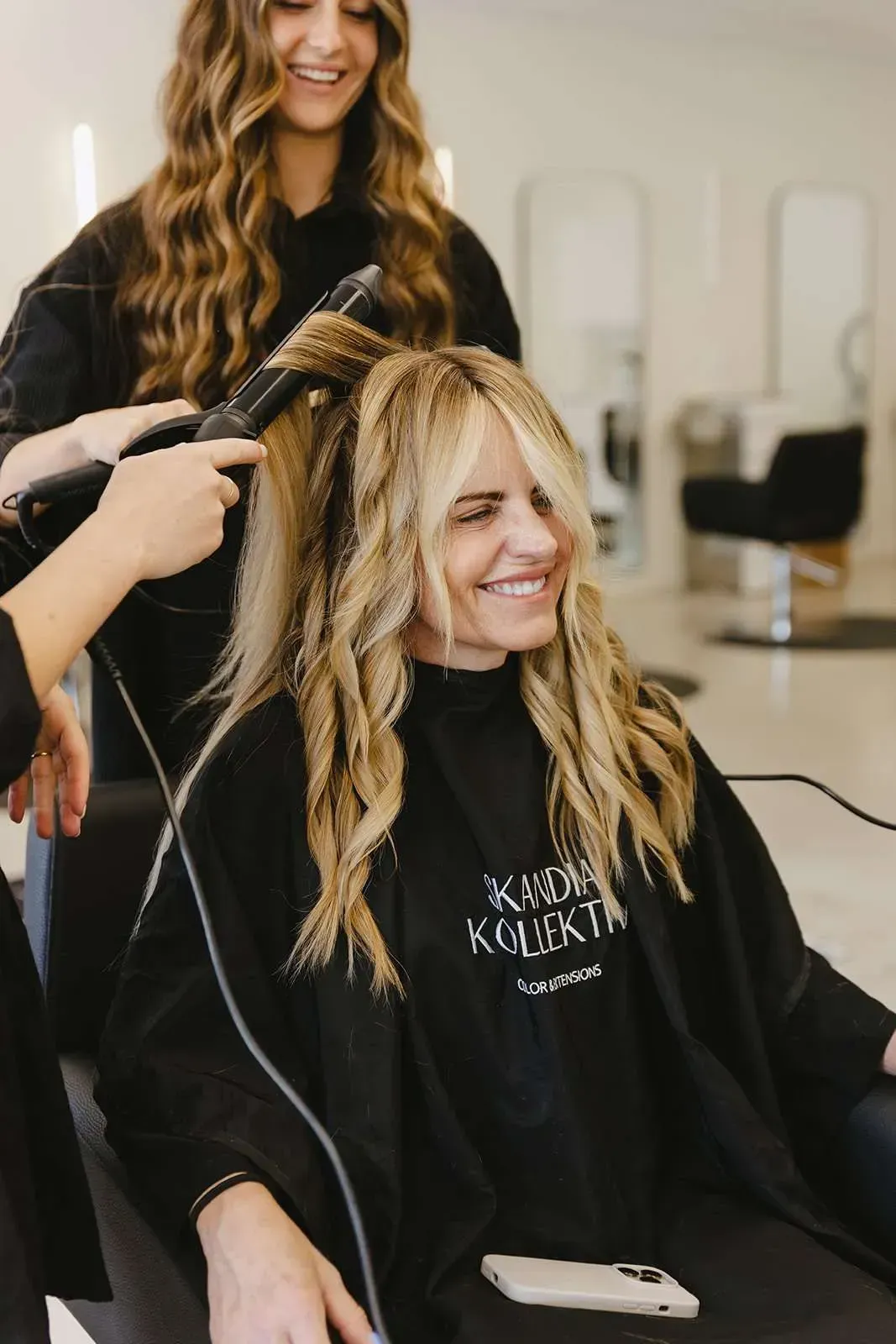 A woman is getting her hair done at a salon