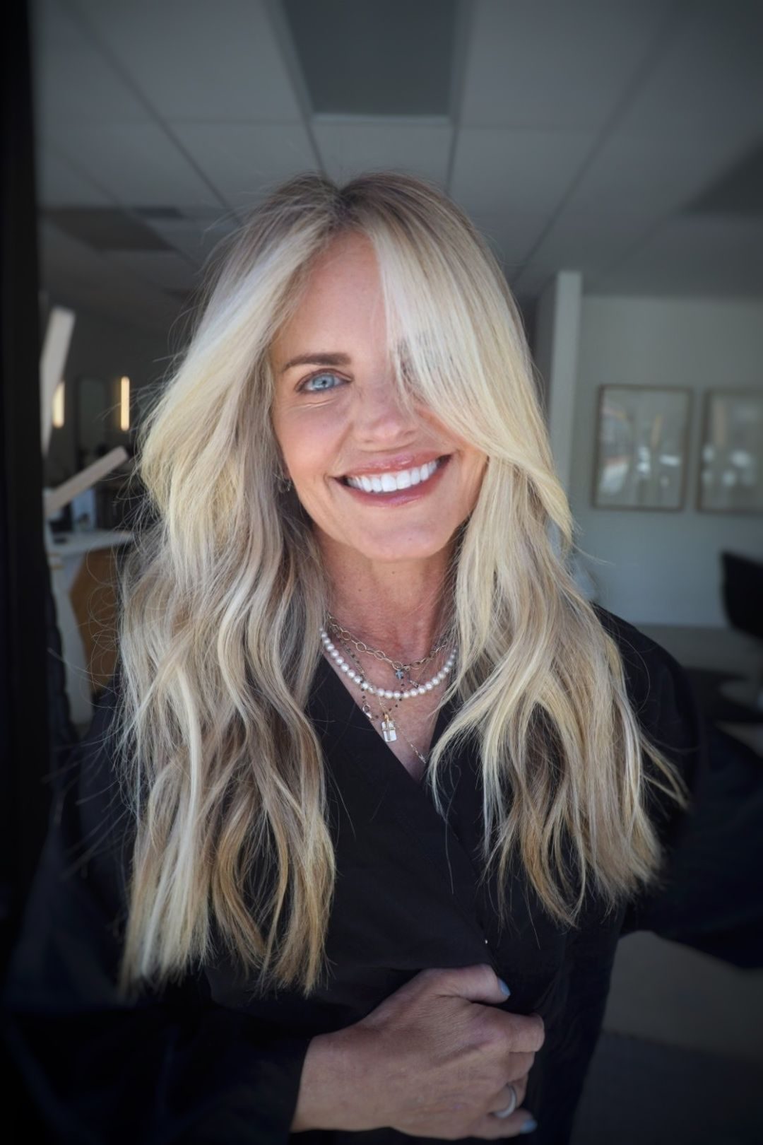Woman with full, natural-looking hand-tied hair extensions at a Salt Lake City salon