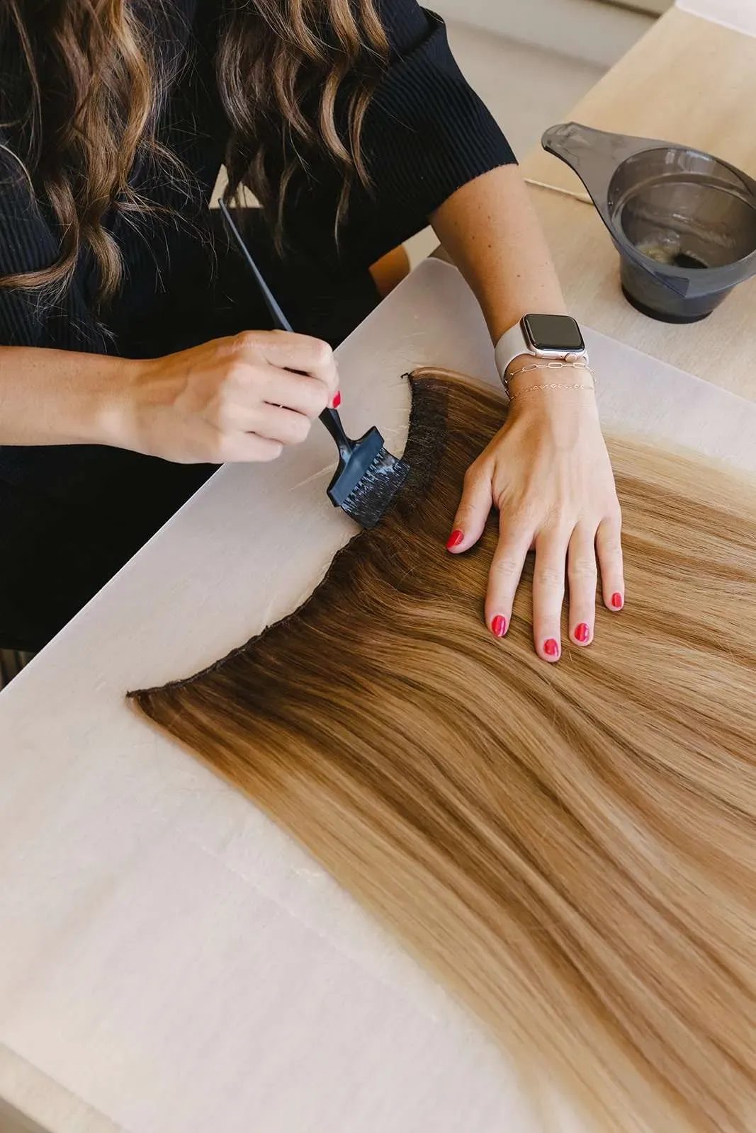 Woman wearing a full high ponytail with hand-tied hair extensions at a Salt Lake City salon